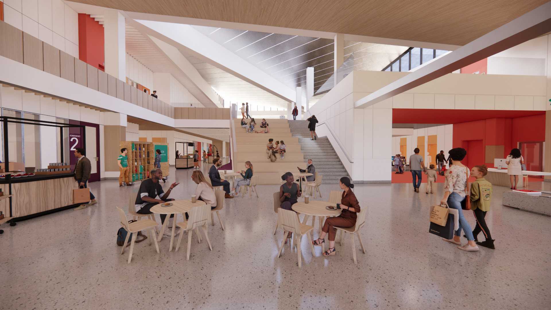 Building atrium with people walking and people sitting at café tables.